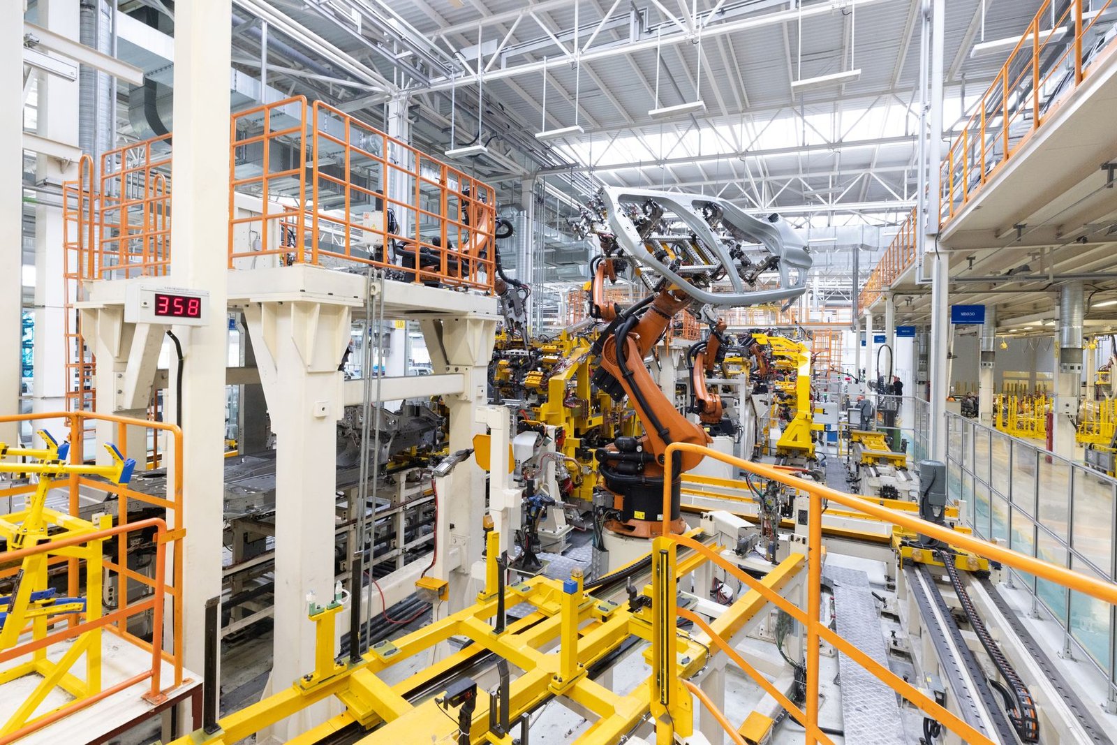 Robotic welding on a car assembly line representing the manufacturing talent Maruti Suzuki and Gujarat are training for